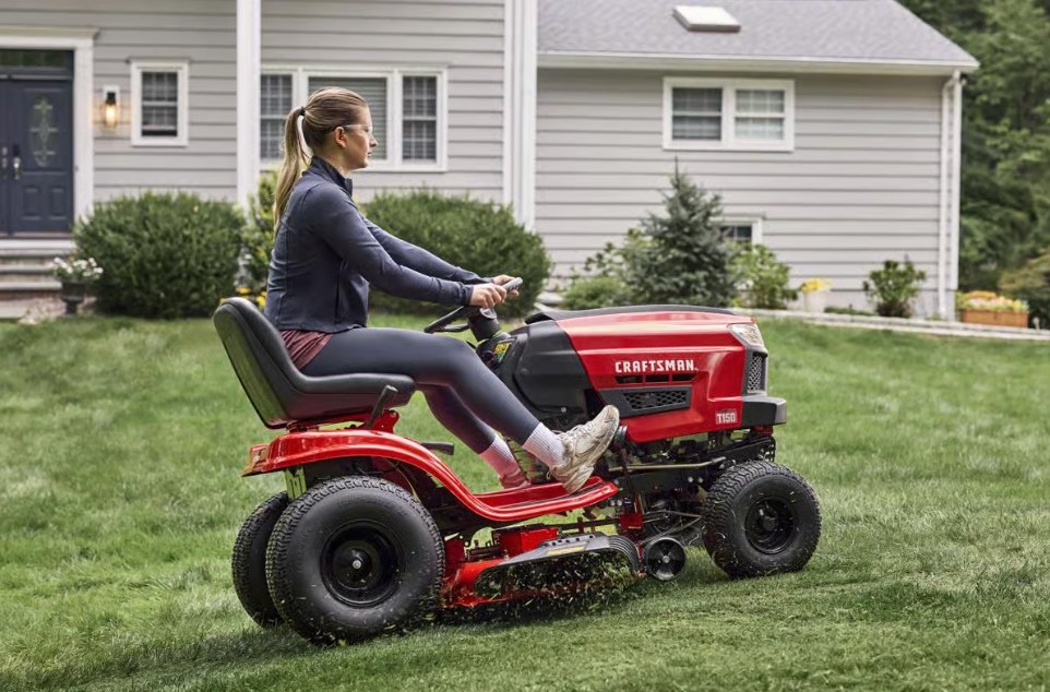 Homeowner mowing a front lawn with the CRAFTSMAN T150